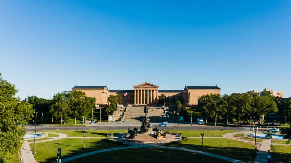 old museum of art near sculptures and lawn in philadelphia